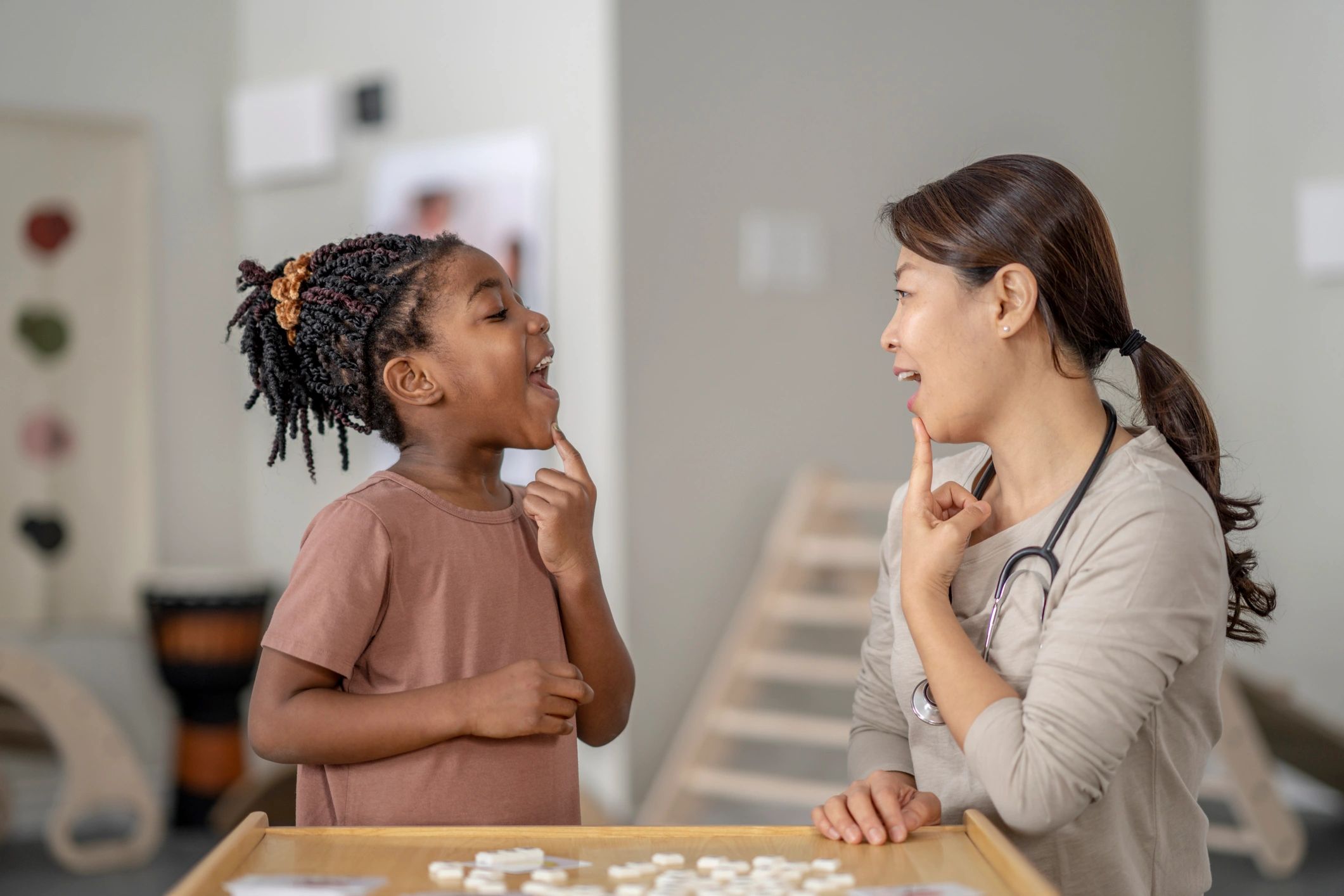 female speech therapist working with children at home